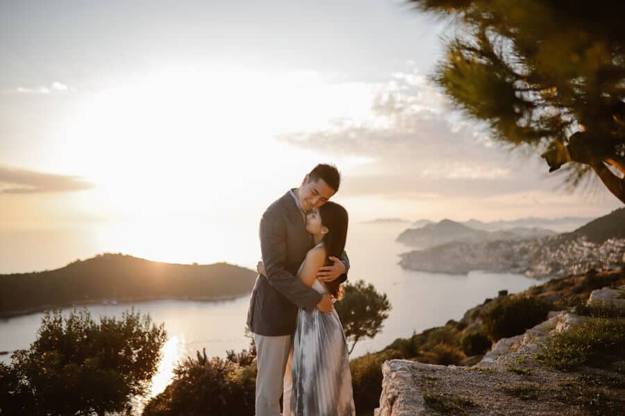 couple hugging in park orsula near Dubrovnik during their honeymoon in Croatia.